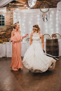 The bride dances with her bridesmaid at Gledswood Estate